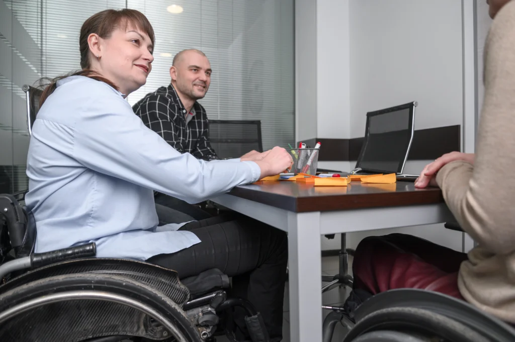 Support coordinator reviewing NDIS plan documents with participant in Queensland